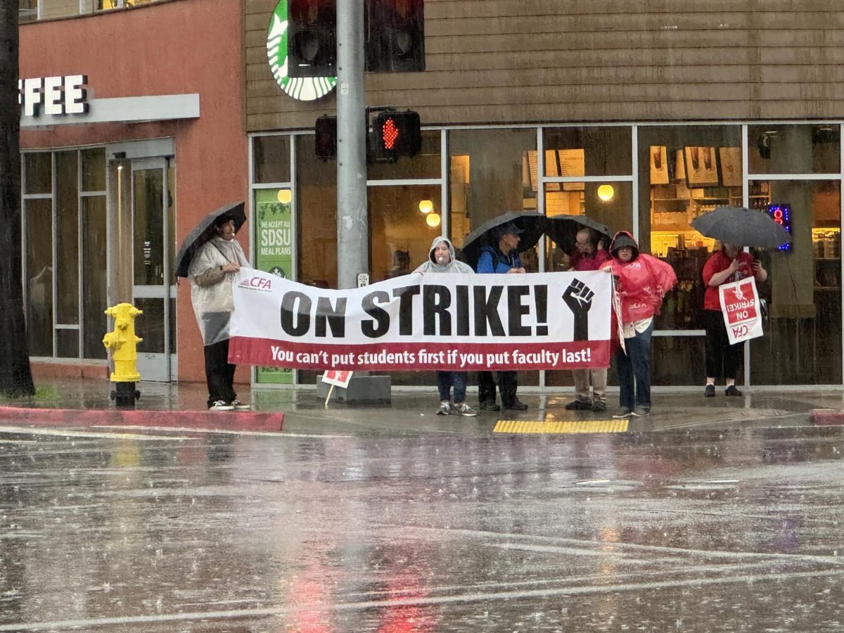 CFA strikers stand in pouring rain at the intersection of College Avenue and Linda Paseo near the campus of SDSU, Monday, Jan. 22, 2024. The strike comes after demands for a 12% raise for faculty were rejected by CSU in favor of a 5% increase over the span of three years. Photo by Susana Serrano/City Times Media