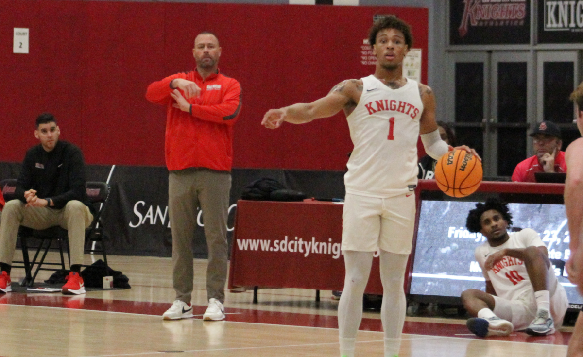 San Diego City College Head Coach Mitch Charlens, center, and guard Keavie Love (1), direct the Knight offense against San Diego Miramar, Feb. 16, 2024. Photo by Danny Straus/City Times Media