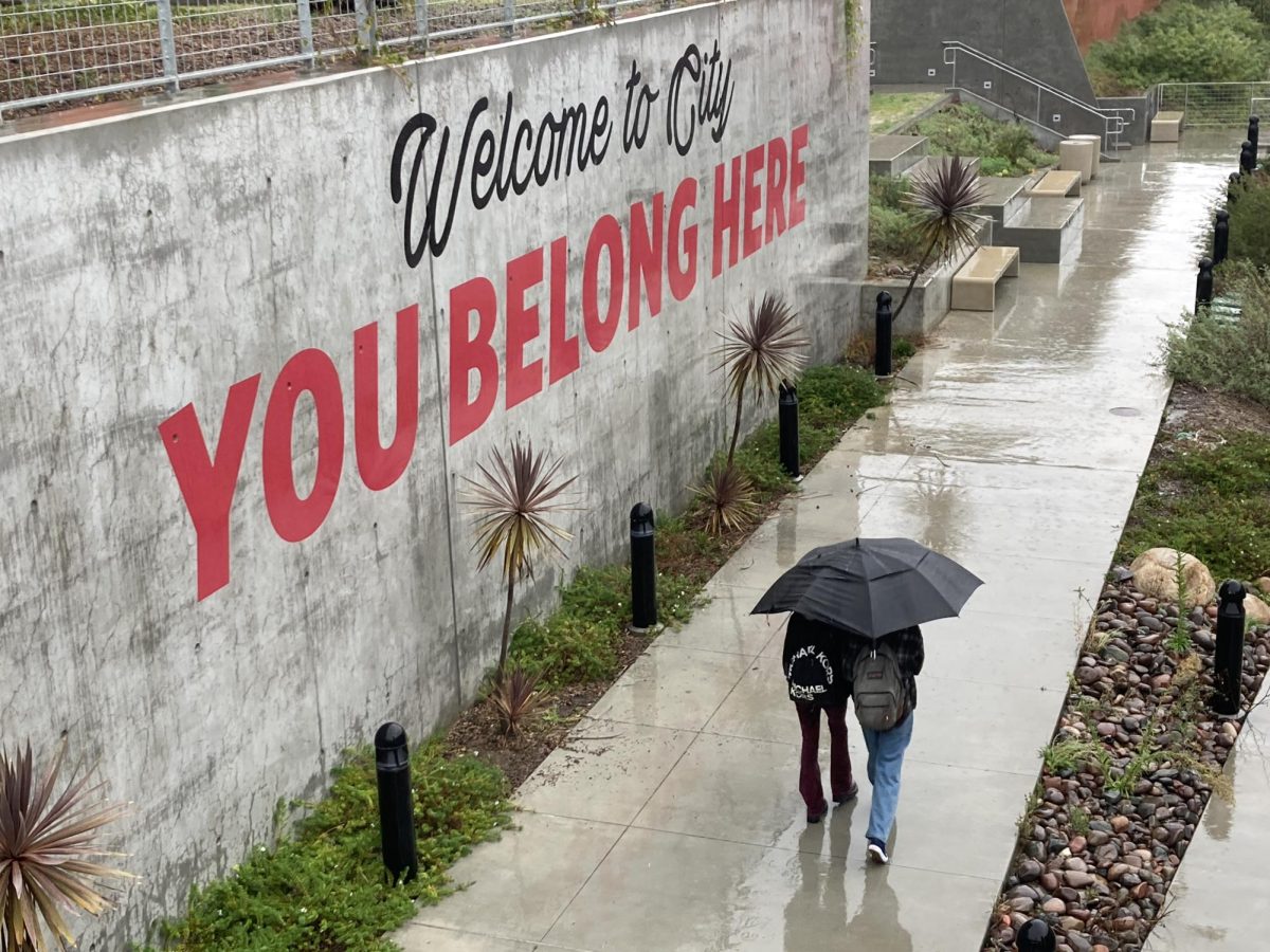 San Diego City College students Tanner Frank and Dahlia Davis walk along campus during the first of two storms that will hit San Diego beginning Thursday, Feb. 01, 2024. Photo by Marco Guajardo/City Times Media