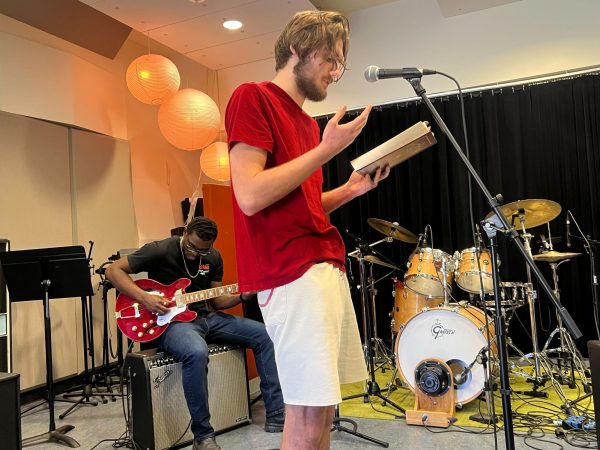 Bernard Clark, left, plays guitar while Jacob Haynes, right, reads an excerpt from “Inferno” by Dante Alighieri at the San Diego City College Music Club Open Mic Night Friday, Mar. 1, 2024. Photo by Nadia Lavin/City Times Media