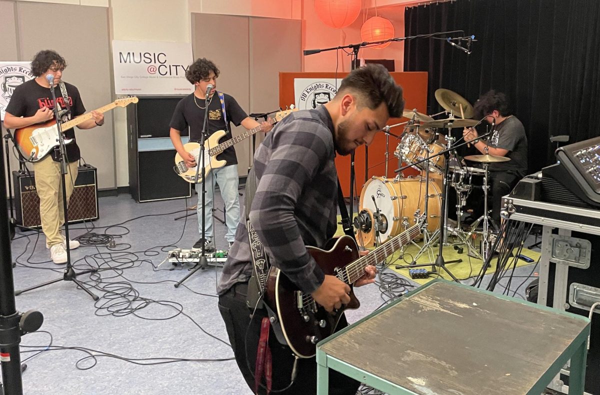 City College student and rhythm guitarist Jesus Gomez, center, plays alongside local band, Promised Paradigm in San Diego City College’s recording studio on Wednesday, March 6, 2024. Photo by Danny Straus/City Times Media