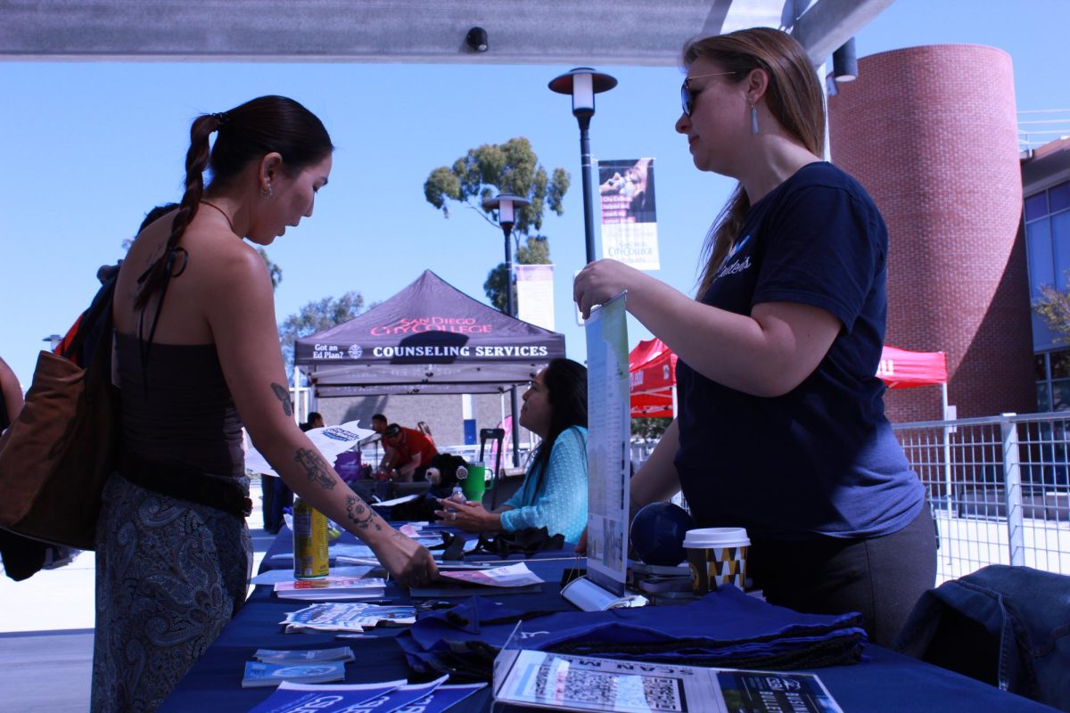 Ayana Coha, left, a second year theater student discusses opportunities at CSU San Marcos with Christina Montell, right at the San Diego City College Spring 2024 Transfer Fair, Tuesday, April 16 2024. Coha said the fair felt “informative and personable.” Photo by Nadia Lavin/City Times Media