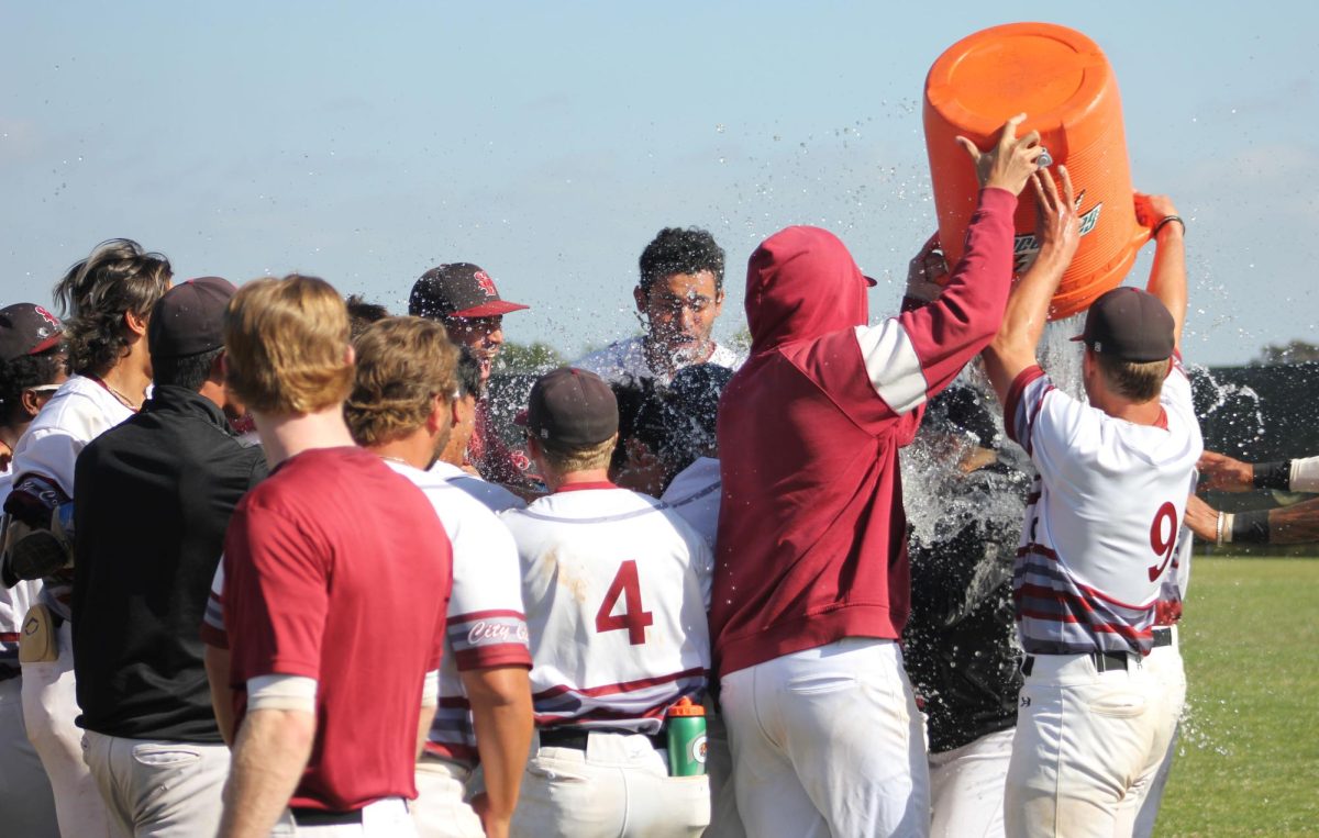 San+Diego+City+Colleges+baseball+team+celebrates+their+9-8+walk+off+victory+over+Mesa+College+by+dousing+Coach+Chris+Brown+with+Gatorade+at+Morley+Field+Friday%2C+April+19%2C+2024.+Photo+by+Danny+Straus%2FCity+Times+Media+
