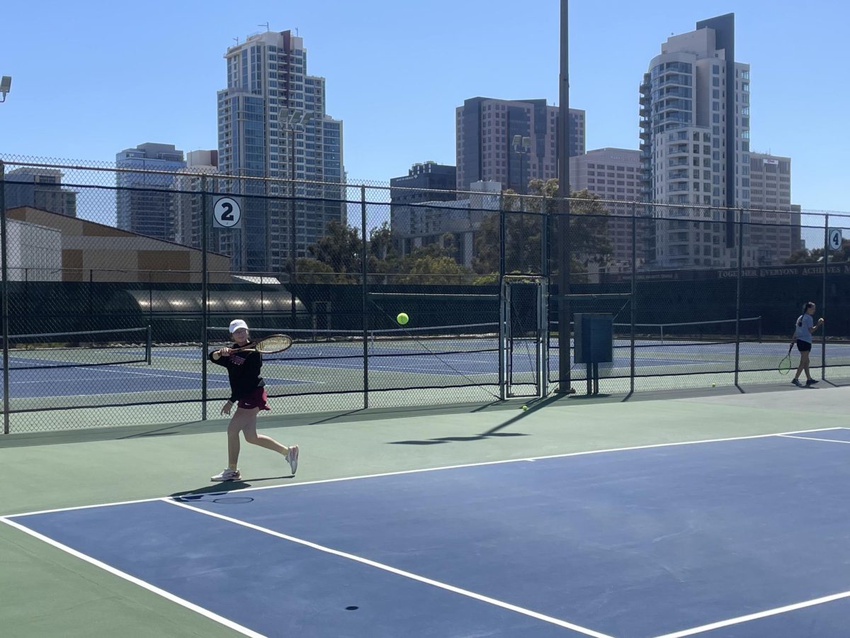  Sophomore tennis player Madeline Satrya returns a volley in practice in front of the backdrop of downtown San Diego at the City College tennis courts Monday, April 8, 2024. Photo by Danny Straus/City Times Media 