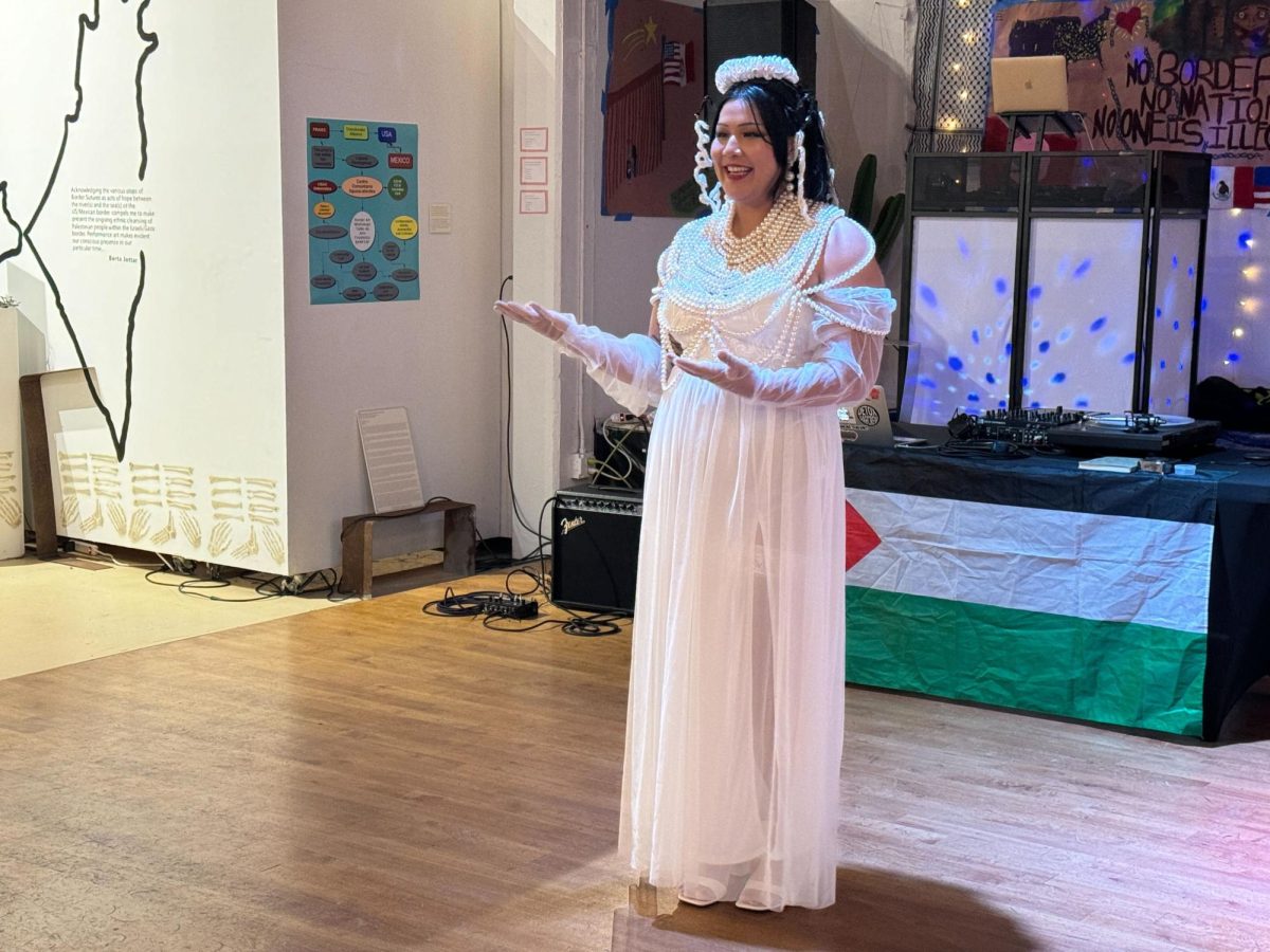 Chicano Studies student Alice Xaymountry recites her poem ‘In a German Library’ at Centro Cultural De la Raza for the Arte en Resistencia opening ceremony, Friday, May 10, 2024. Photo by Susana Serrano/City Times Media
