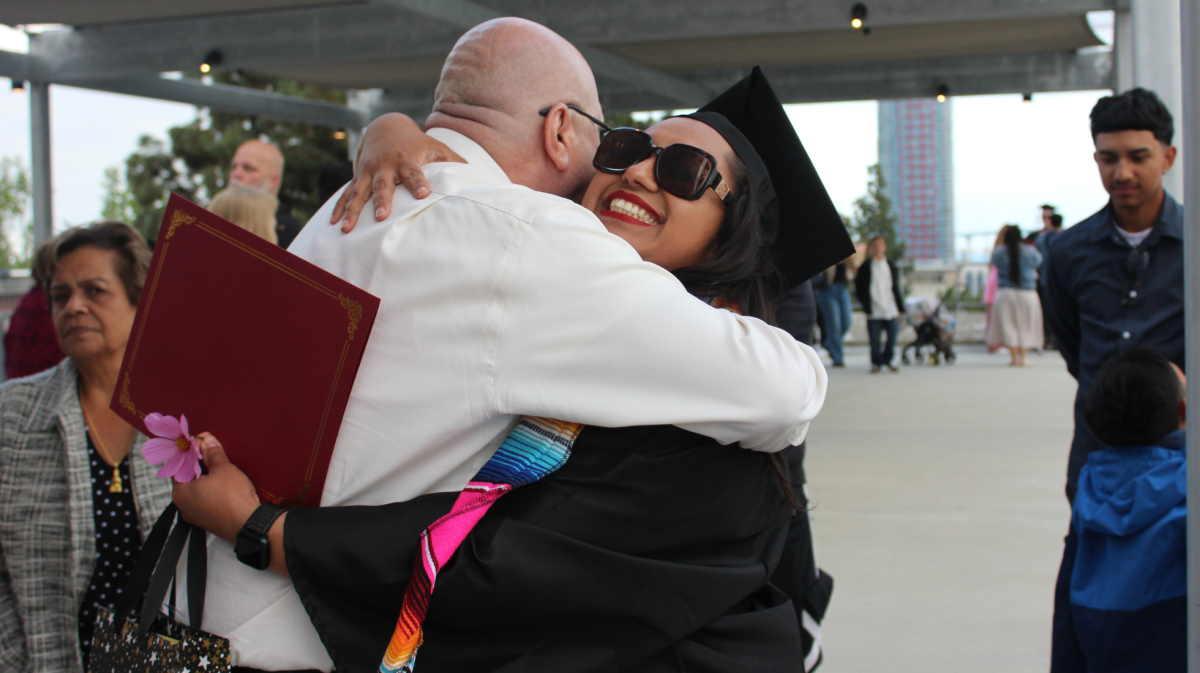 Biology in Allied Health and Language Arts and Humanities graduate Cristal Conde, right, and her stepfather Miguel Solis, left, hug after the Chicano/Latina Graduation ceremony, Thursday, May 17, 2024. Photo by Susana Serrano/City Times Media
