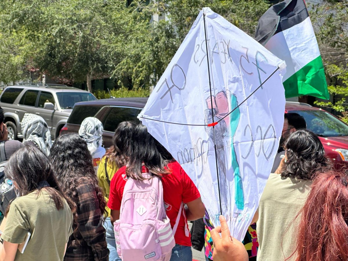 A protester at the San Diego City College Student Walkout holds a kite, Tuesday, May 7, 2024. The kite was made to honor Palestinian poet Refaat Alareer who was killed by Israel, according to Chicano/a Studies Professor América Martinez. Photo by Bailey Kohnen/City Times Media