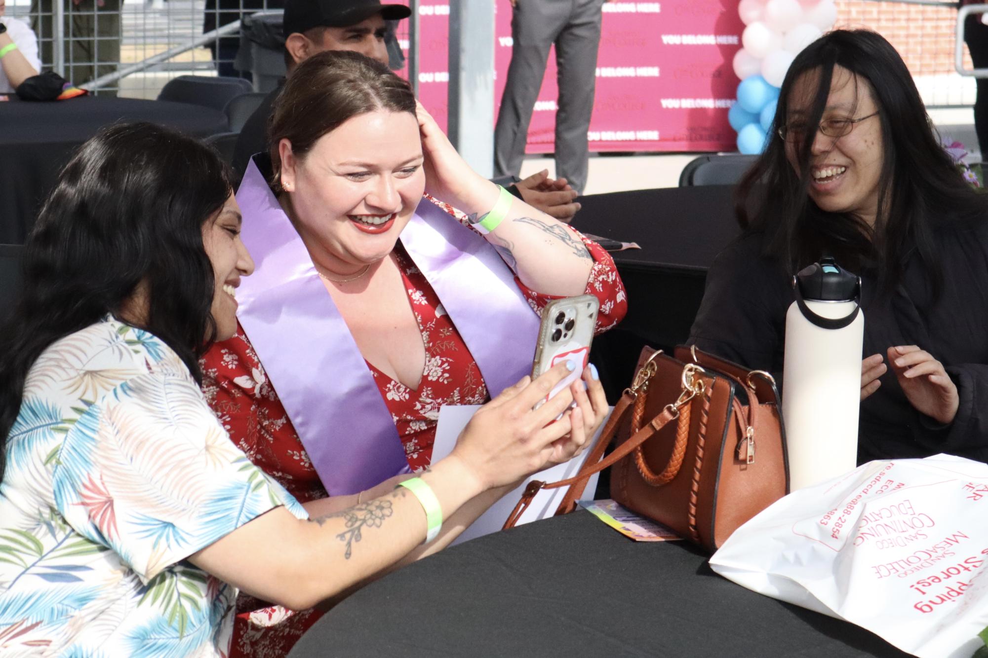 Asia Raymond, left, and Elaine Eng, right, celebrate their friend Monique Dunn, center, during the Lavender Graduation at San Diego City College, May 9, 2024. Photo by Samantha Griffen/ City Times Media