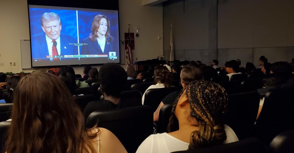 Nadia, foreground left, and Nyhia watch former President Donald Trump and Vice President Kamala Harris at the presidential debate watch party presented by the San Diego City College political science program on Tuesday, Sept. 10, 2024. Photo by Vince Outlaw/City Times Media