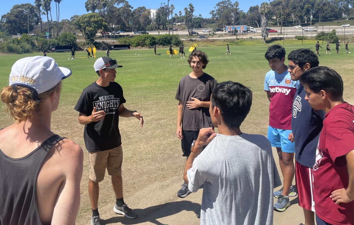  Phillip Dunn, City College men's cross country head coach, left instructs his runners during practice, Aug. 26, 2024. Photo by Danny Straus/City Times Media
