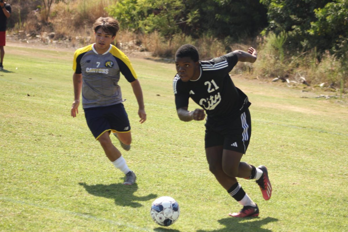 City College freshman Jamesley Exantus (21) dribbles away from College of the Canyon’s defender Andrew Montes (7)  at home Friday, August 30, 2024. Photo by Danny Straus/City Times Media 