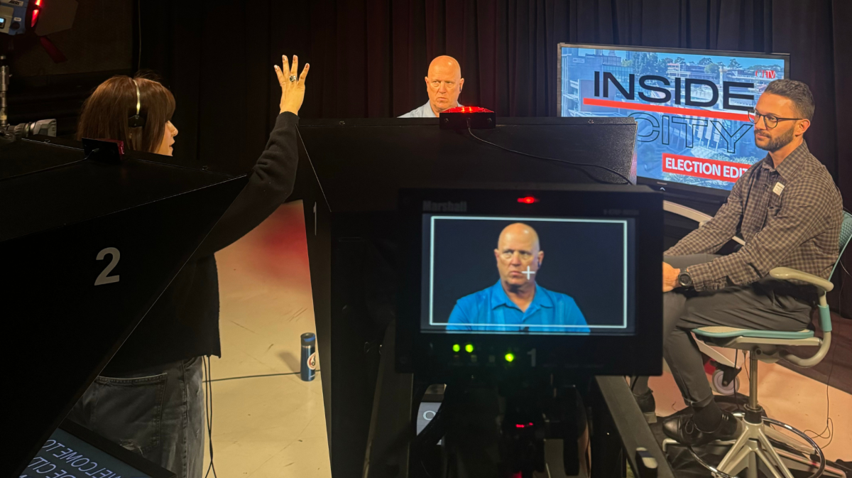 CTTV's Vince Outlaw, center, prepares to interview Welcome Home City's Michael Evans in the campus TV studio, Wednesday, October 23, 2024. CTTV's Sarai Gomez Huerta works as floor director. Photo by Daniele Luna/City Times Media