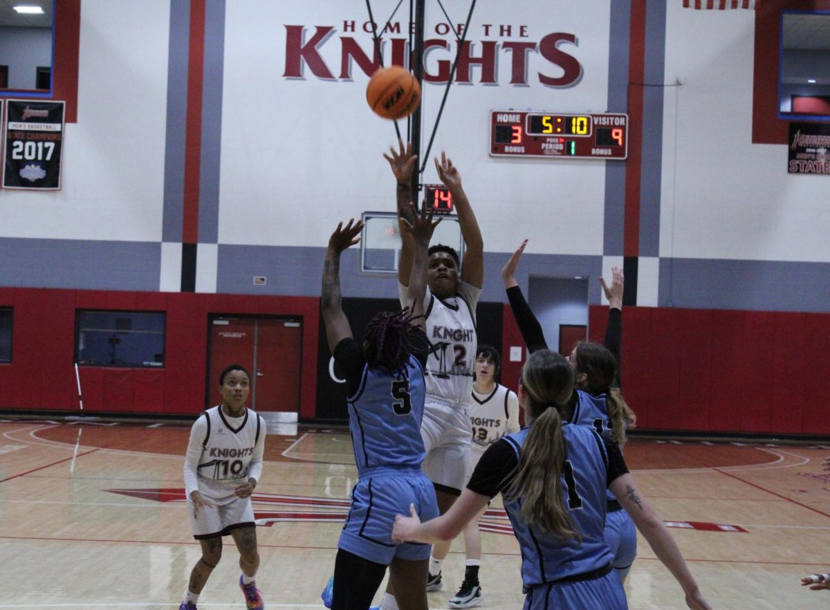 City College freshman Dahlia Blake (2) shooting over three Cerra Coso defenders in the first quarter against Cerra Coso at Harry West Gym, Thursday, Nov. 21, 2024.