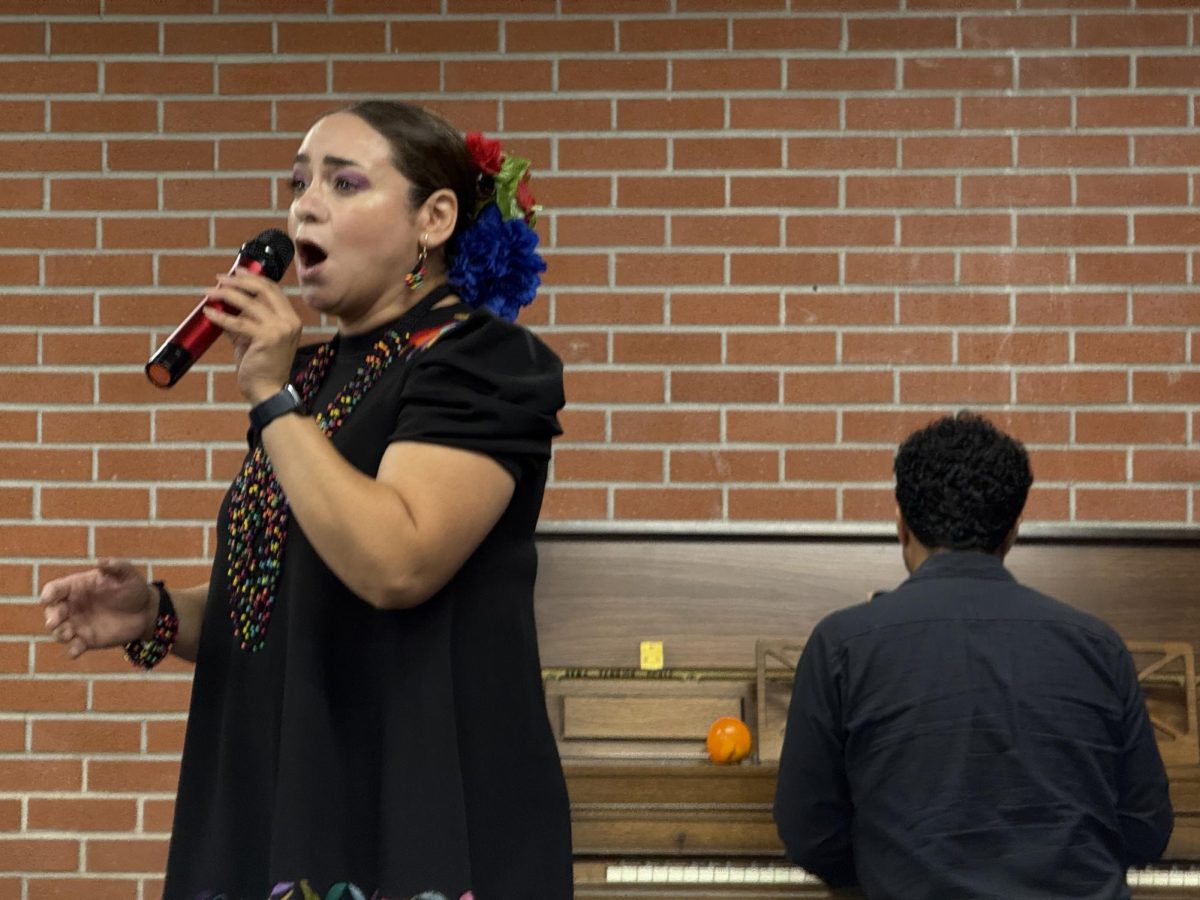 Zully Martinez, left, sings a solo accompanied by Ivan Mares, right, who was playing the piano during the Día de los Muertos campus event Wednesday, Oct. 30, 2024