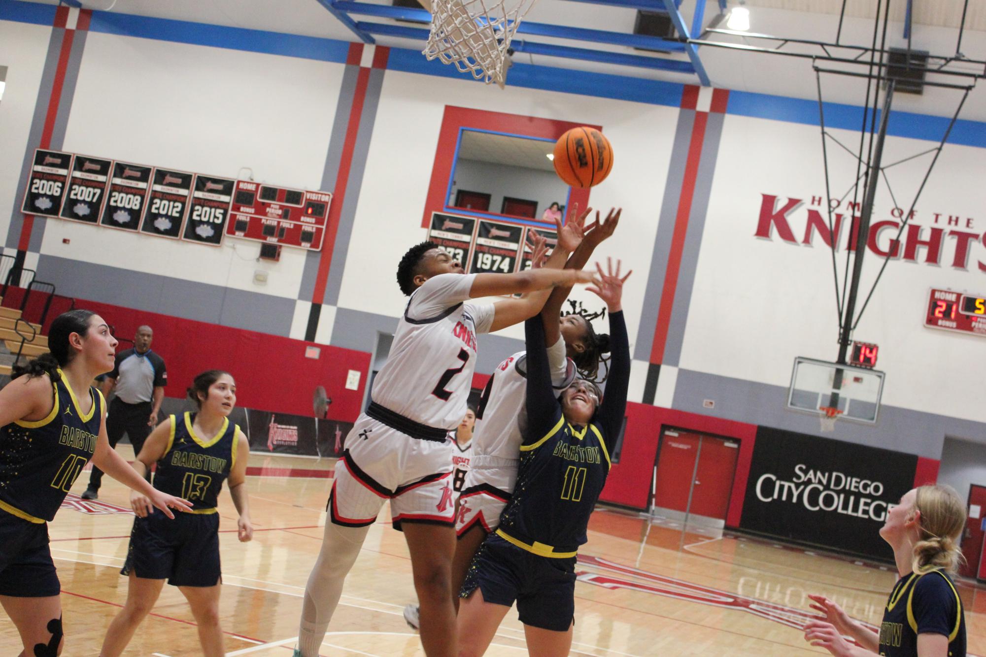  City College freshmen Dahlia Blake (2) and Aamori Daniels (4) attempt to grab a rebound over Barstow guard Leanne Domingo (11) in second-half action at Harry West Gym, Friday, Dec. 6, 2024. Photo by Danny Straus/City Times Media 
