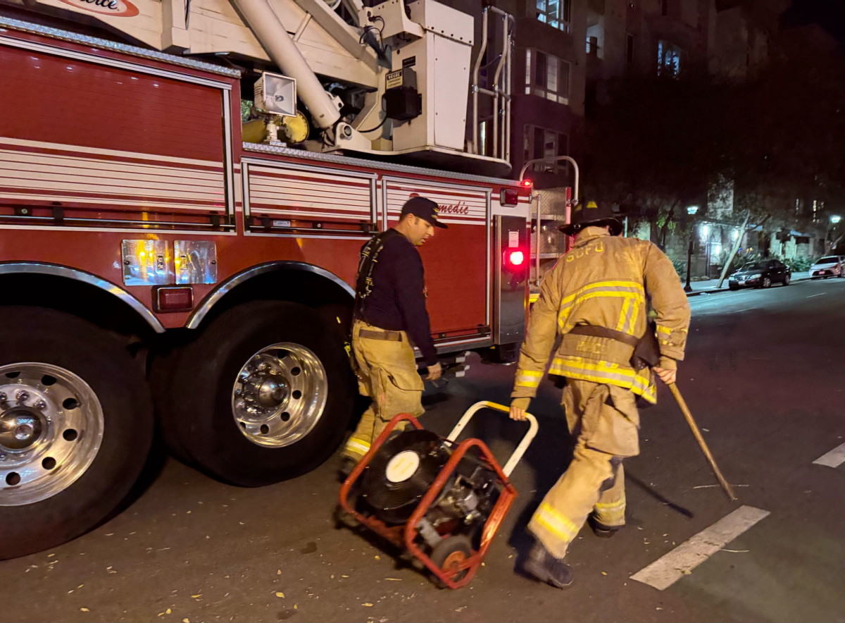 Two City of San Diego Fire truck 11 firefighters, who declined to share their names, prepare to load a positive pressure ventilator back onto their truck, Tuesday, Dec. 10, 2024. The eight-man team responded to reports of a fire in the AH Building at San Diego City College. Photo by Yonatan “Yogi” Hernandez/City Times Media
