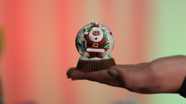 CTTV’s Sarai Gomez Huerta shows a no-bake snow globe treat, one of two recipes shared this holiday season by City Times Media, Wednesday, Dec. 11, 2024. Photo by Daniela Luna/City Times Media