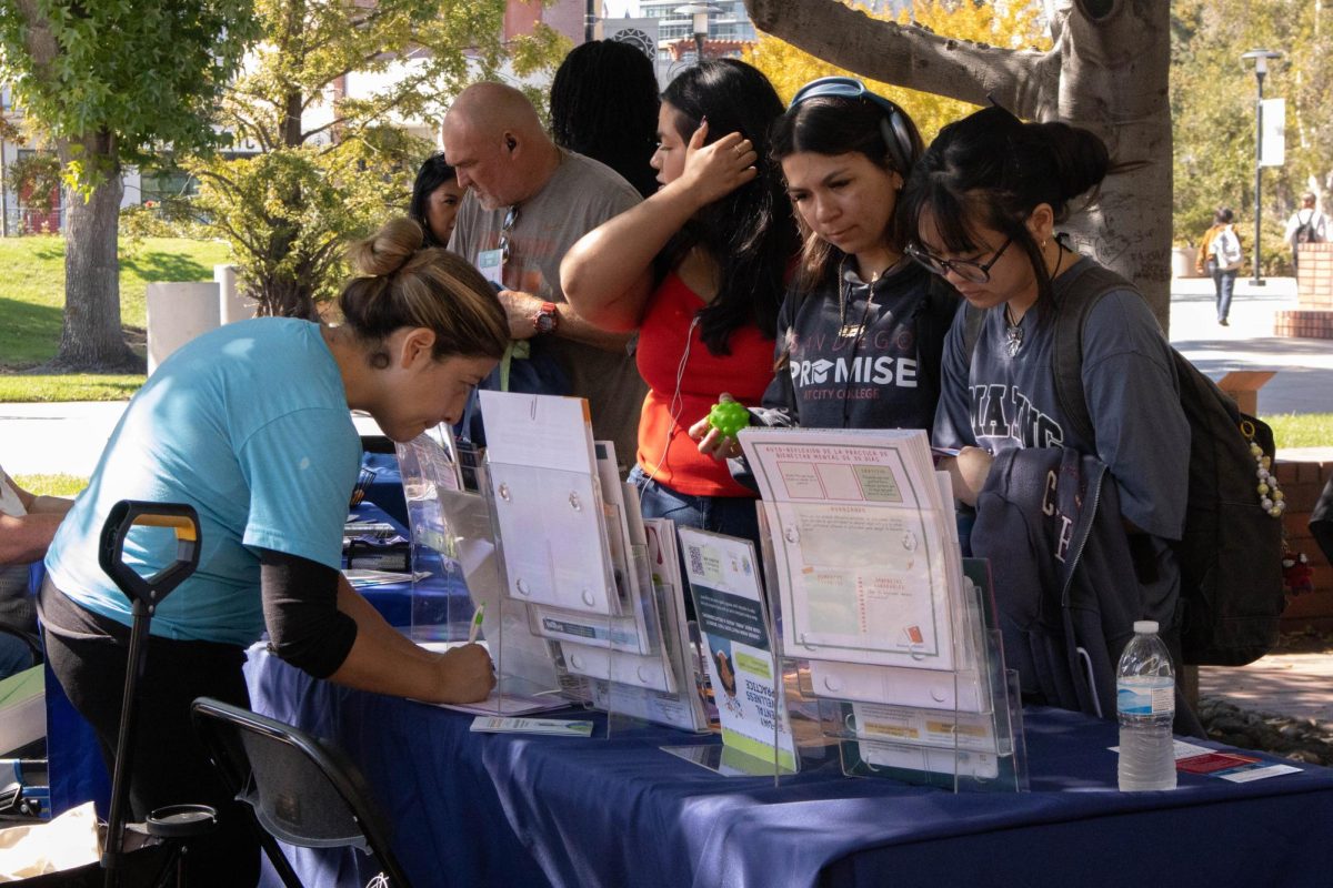 City College students talk with representatives from San Diego Youth Services, where they are provided with information on the resources offered at the Suicide Prevention Fair held at Gorton Quad, Tuesday, Sept. 29, 2025. Photo by Briana Bush/City Times Media