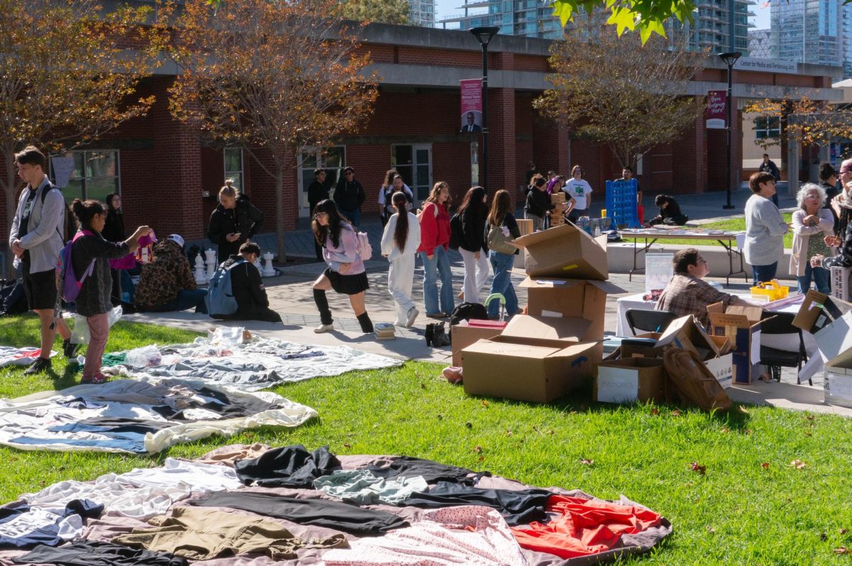 Students walk around Curran Plaza during the free gift exchange event looking at the various donations the event offers, Wednesday, Nov. 19, 2025. Photo by Briana Bush/City Times Media