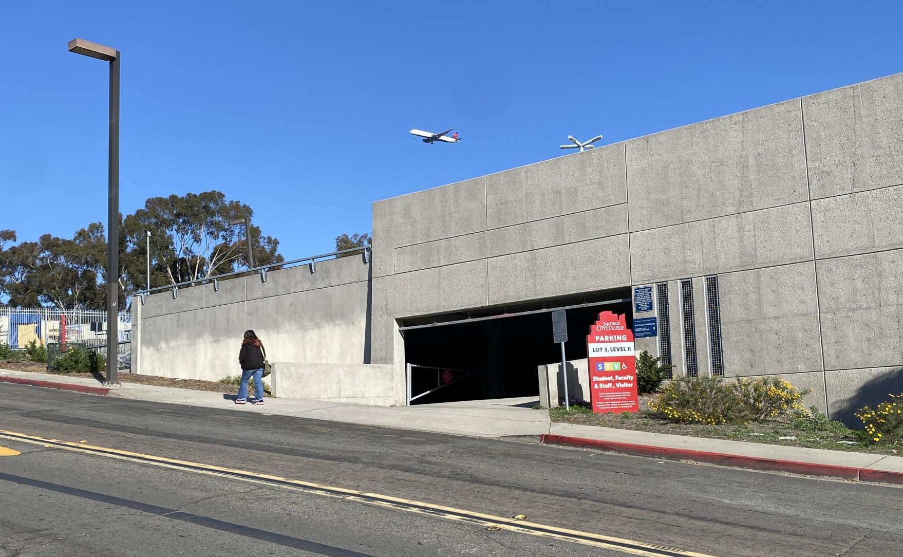A student walks past Lot 3, where earlier this week Immigration and Customs Enforcement activity near the campus of San Diego City College prompted a campus-wide alert, Thursday, Dec. 18, 2025. Photo by David J. Bohnet/City Times Media
