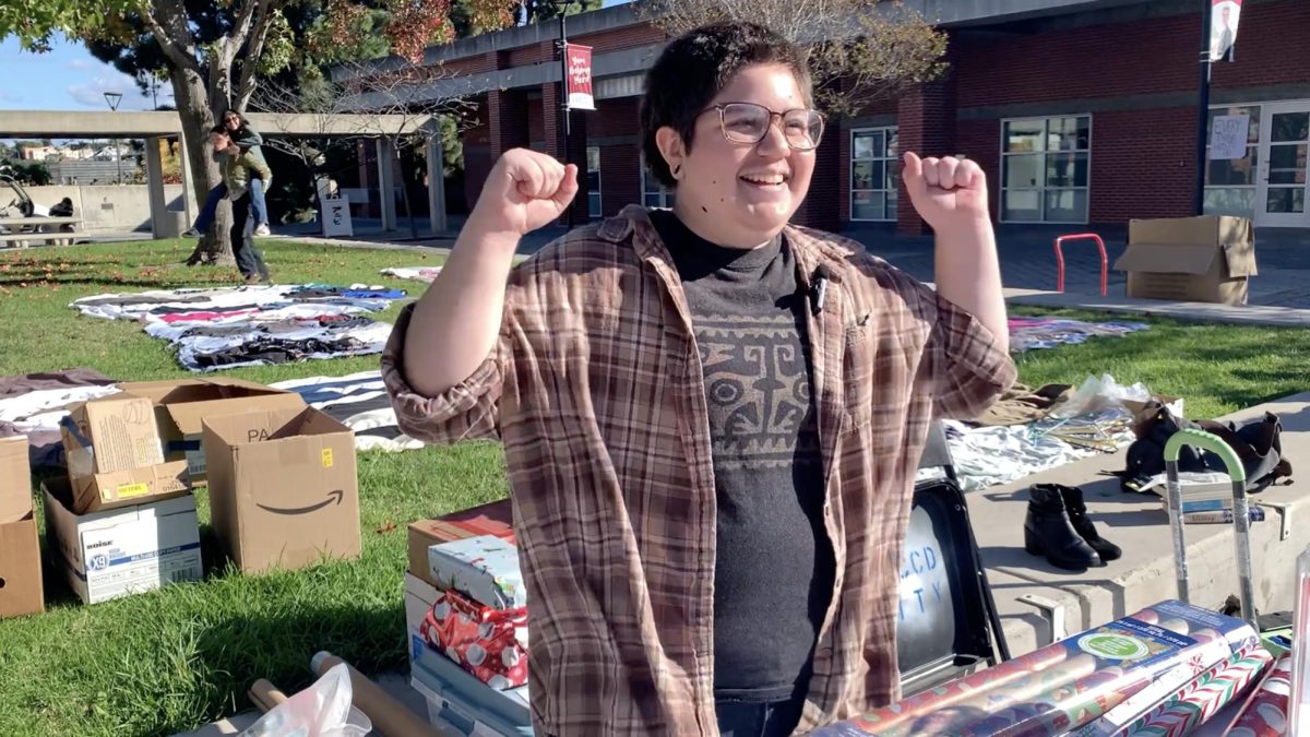 First-year history major Julen Ocegueda cheers in Curran Plaza, as he helps gift wrap during a free campus-wide gift exchange, Wednesday, Nov. 19, 2025. Photo by Varun Chaturvedi/City Times Media