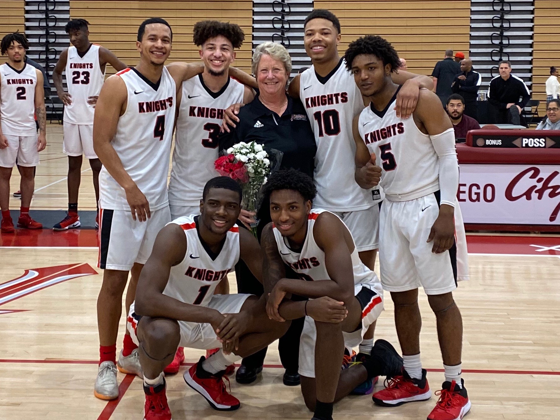 Lory Ray is honored at her last home game with the men's basketball sophomores at Harry West Gym, Feb. 21, 2020. Photo courtesy of Lory Ray