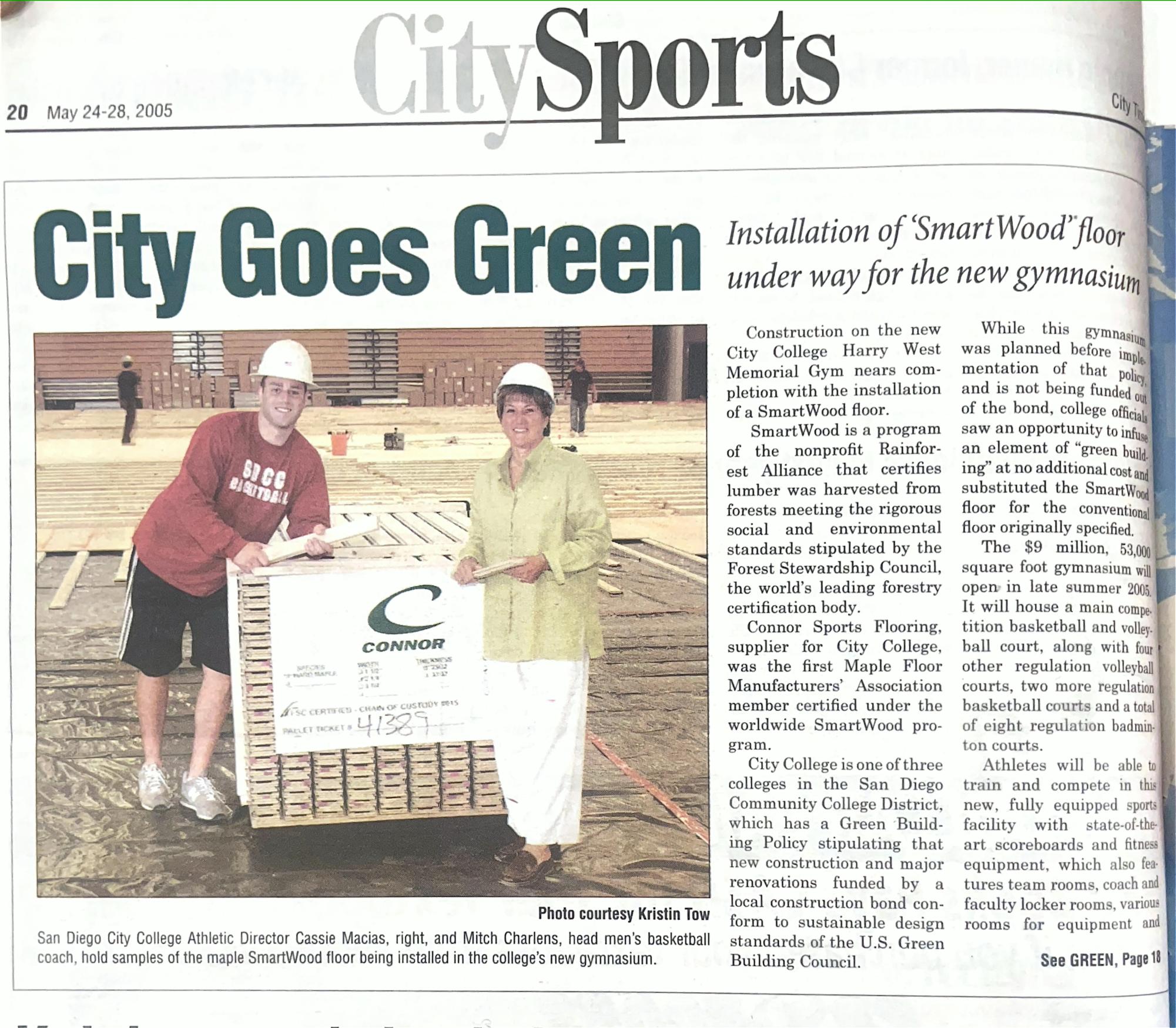 Mitch Charlens, left, and Cassie Macias, right, pose with new gym floor for construction of Harry West Gym in 2005.
