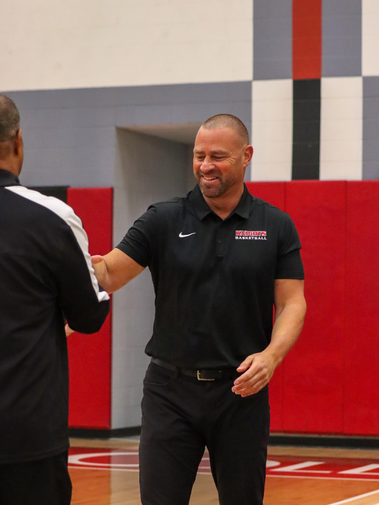Mitch Charlens shakes referee's hand before game at Harry West Gym in an undated photo. Photo courtesy of Gus Celarie
