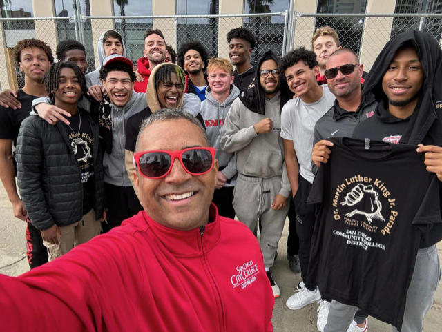 City College president Ricky Shabazz, in red, poses for a selfie with the Knights basketball team at the 2025 Martin Luther King Jr. Day parade in San Diego. Photo courtesy of Ricky Shabazz