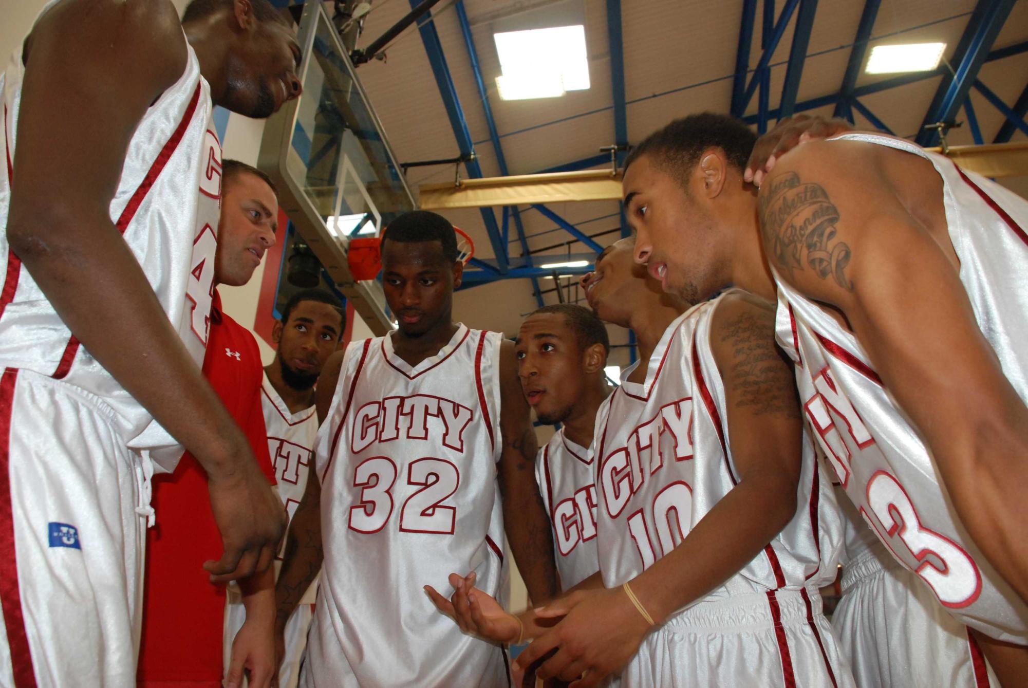 Coach Mitch Charlens, in the red shirt, counsels the men's basketball team in one of their final practices before for the season opener on Nov. 13, 2009.