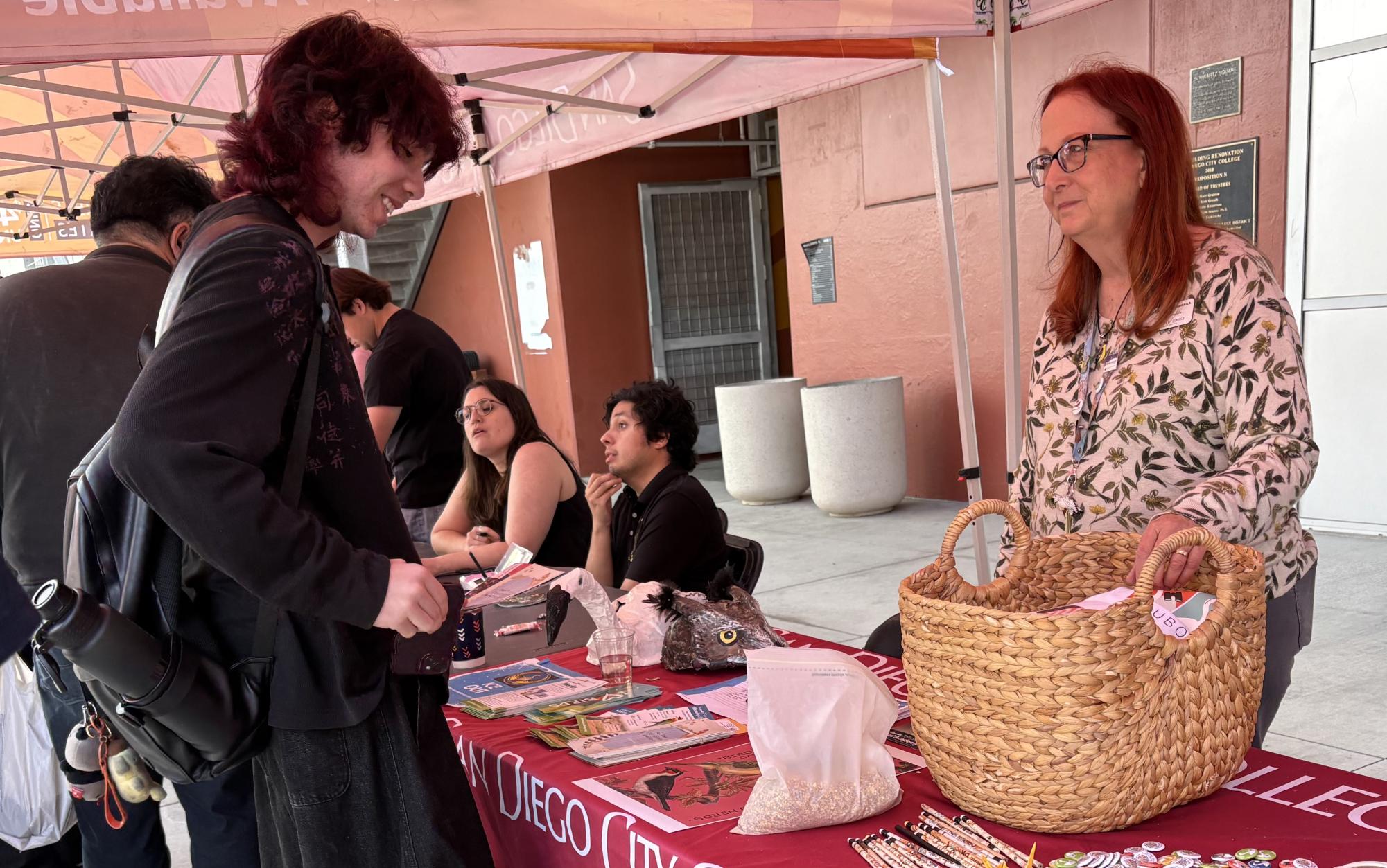 City College student Kalib Frederick, left, discusses the Bird Alliance club with Professor Lisa Chaddock, right, at the City College Valentine’s Day Club Rush event, Thursday, Feb. 12, 2026. Photo by Crow Ruiz/City Times Media