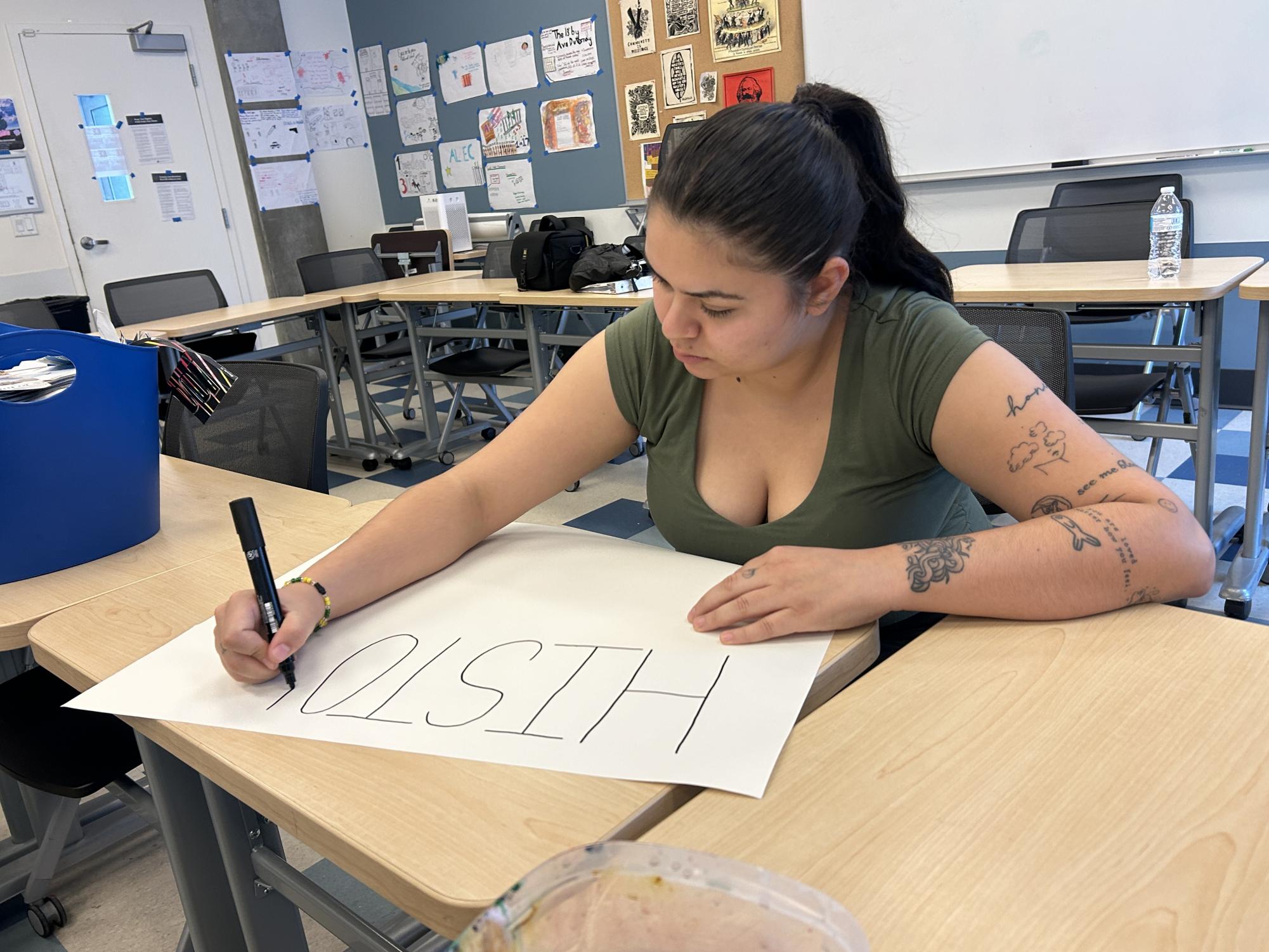 City College student Alexis Espinoza makes a poster for an "ICE Out" rally in MS-521, Tuesday, Feb. 10, 2026. Photo by Nadia Lavin/City Times Media