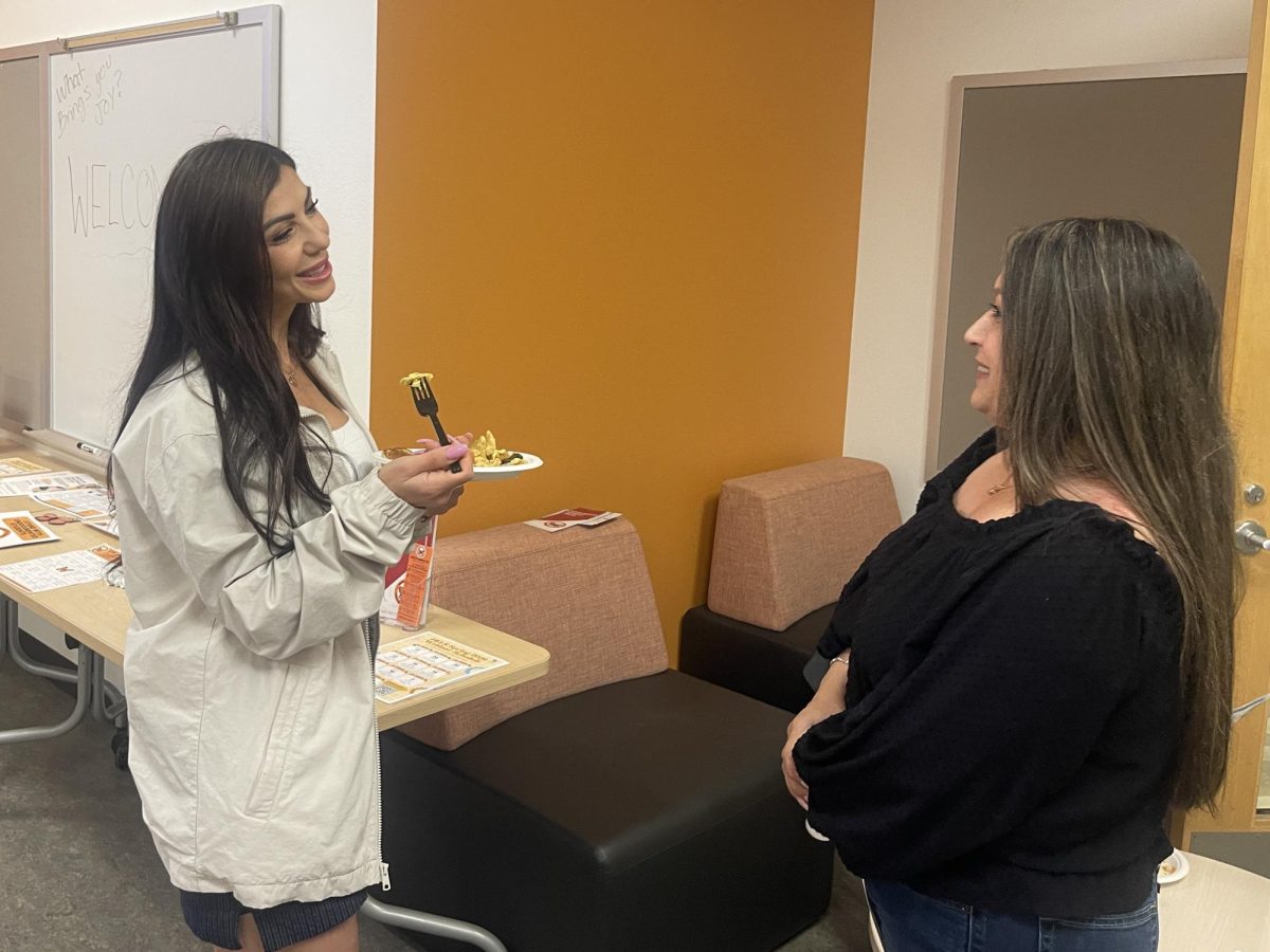 City College CalWORKs program coordinator Miriam Mena, left, talks with Marya Munoz, a financial aid technician, over breakfast at the Undocumented Resource Center Open House and Student Mixer in L-118, Monday, Feb. 9, 2025. Photo by Chrisdan Peralta/City Times Media