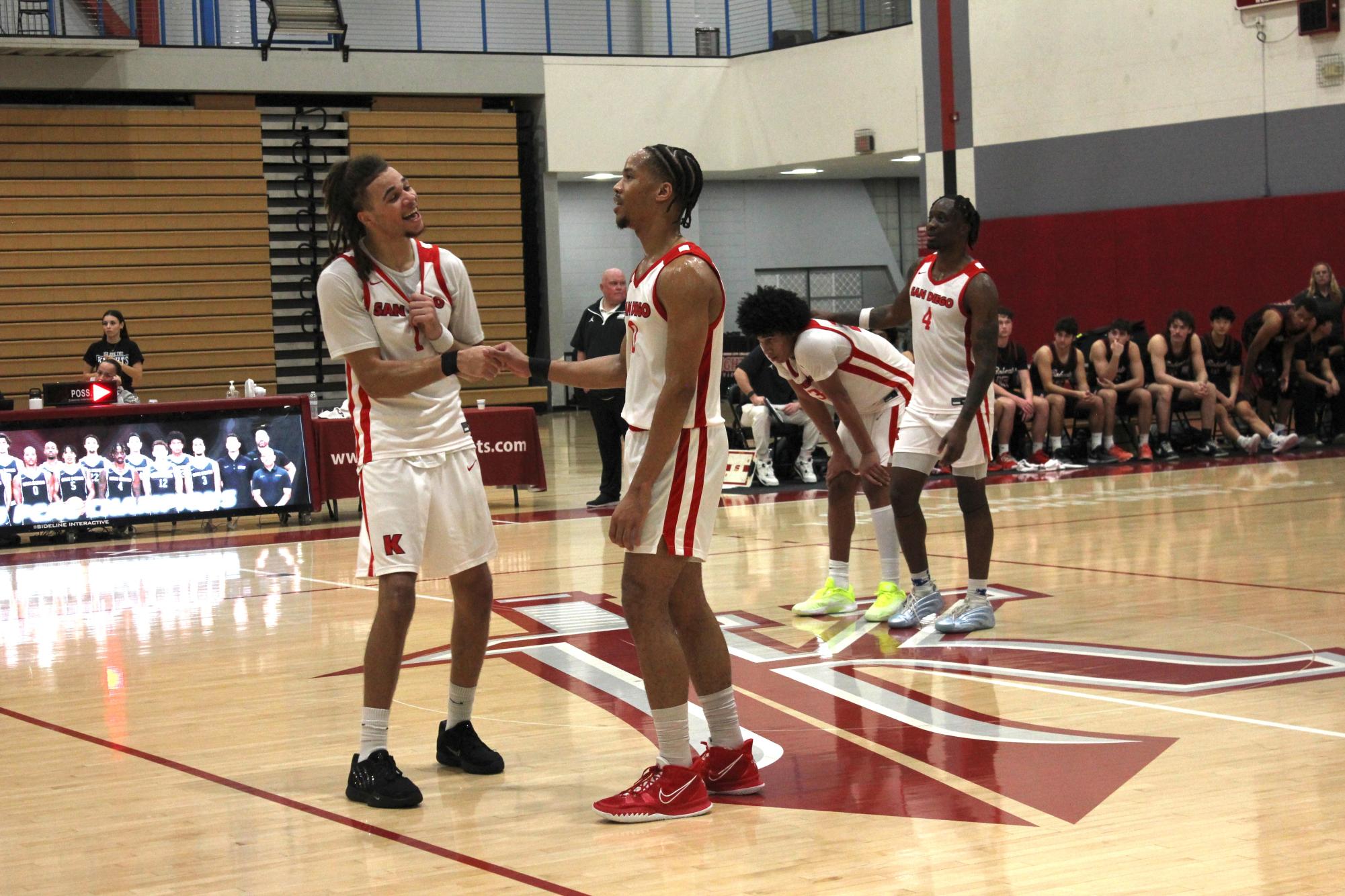 City College guards Micah Brickner (1), left, Pharaoh Amadi (0), front center, Dylan Griffin (23), back center, and Andrew Azebeokhai Jr. (4), back left, celebrate a 79-70 home victory over Saddleback College at Harry West Gym, Saturday, Feb. 28, 2026. Photo by Nadia Lavin/City Times Media