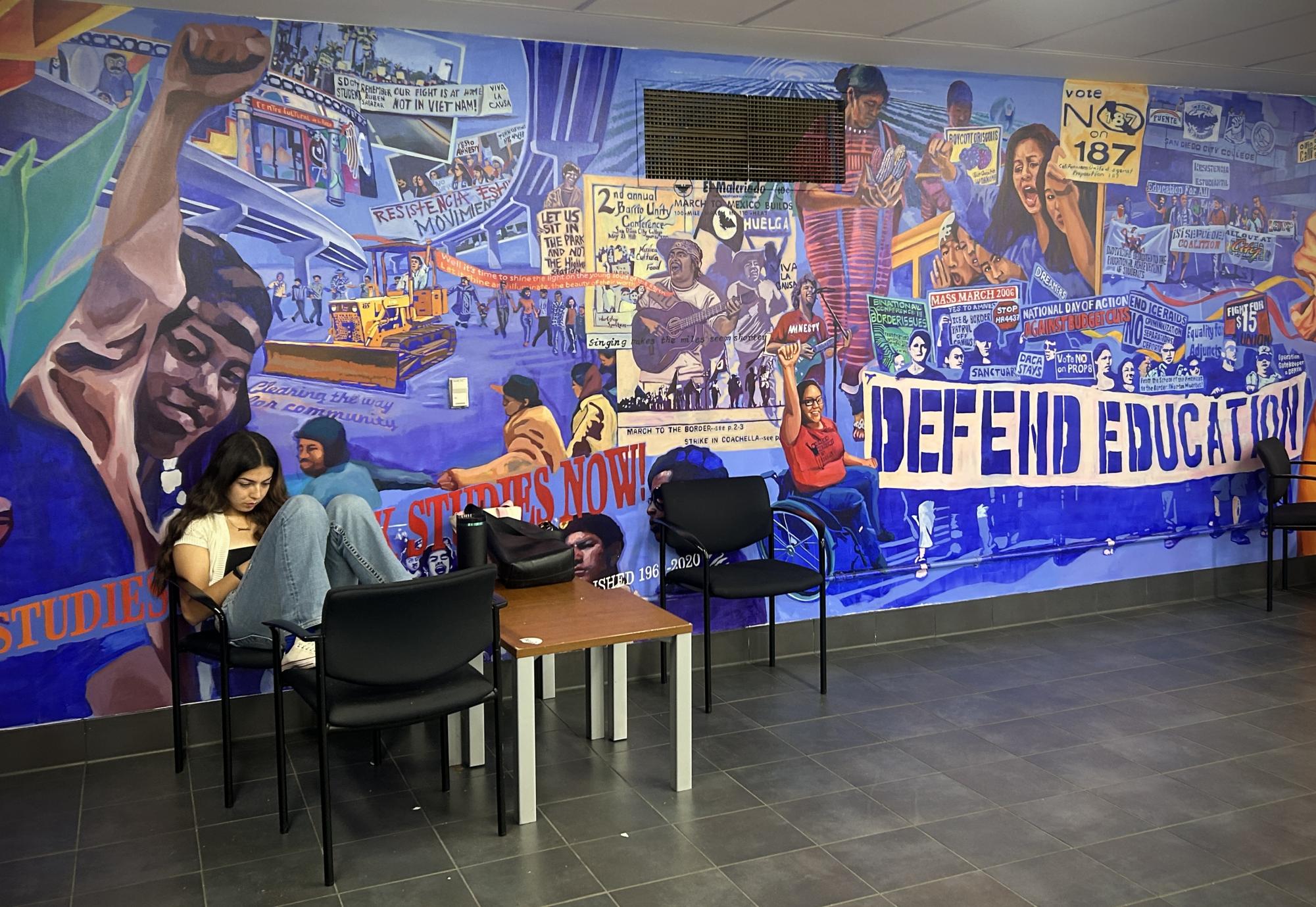 City College student Julianna Magana lounges by a mural that depicts the historic 1000-mile march across California, which was led by Cesar Chavez, at the City Commons, Thursday, March 19, 2026. Photo by Nadia Lavin/City Times Media