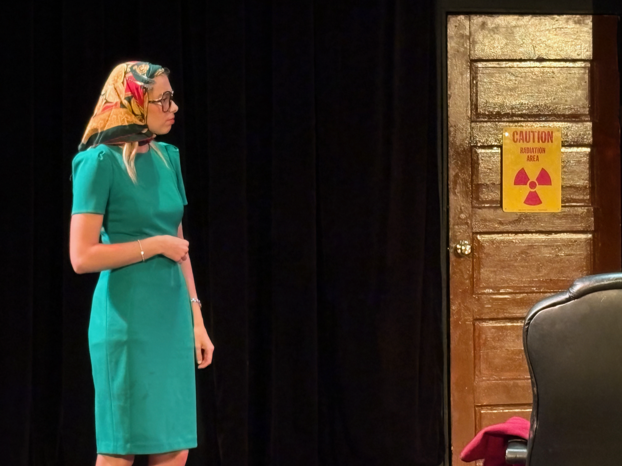 Dottie, played by Lily Wrieden, looks off to the side at Meghan, played by Annaleece Wakefield, in front of a caution sign, foreshadowing what is about to happen at the Black Box Theater, Thursday, March 19, 2026. Photo by Crow Ruiz/City Times Media