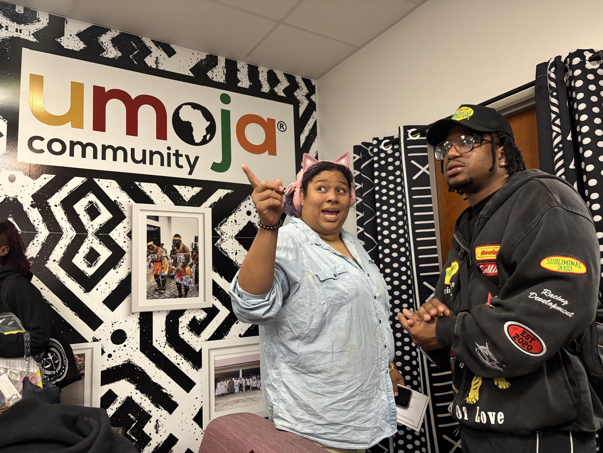 Mookie Kuresa Umoja student, left, discusses with Javontee Hill, right, about the afrocentric decor, at the opening of the Black Excellence Resource center, in room T-220, Thursday, Feb. 26, 2026. Photo by Samira Hassan/City Times Media
