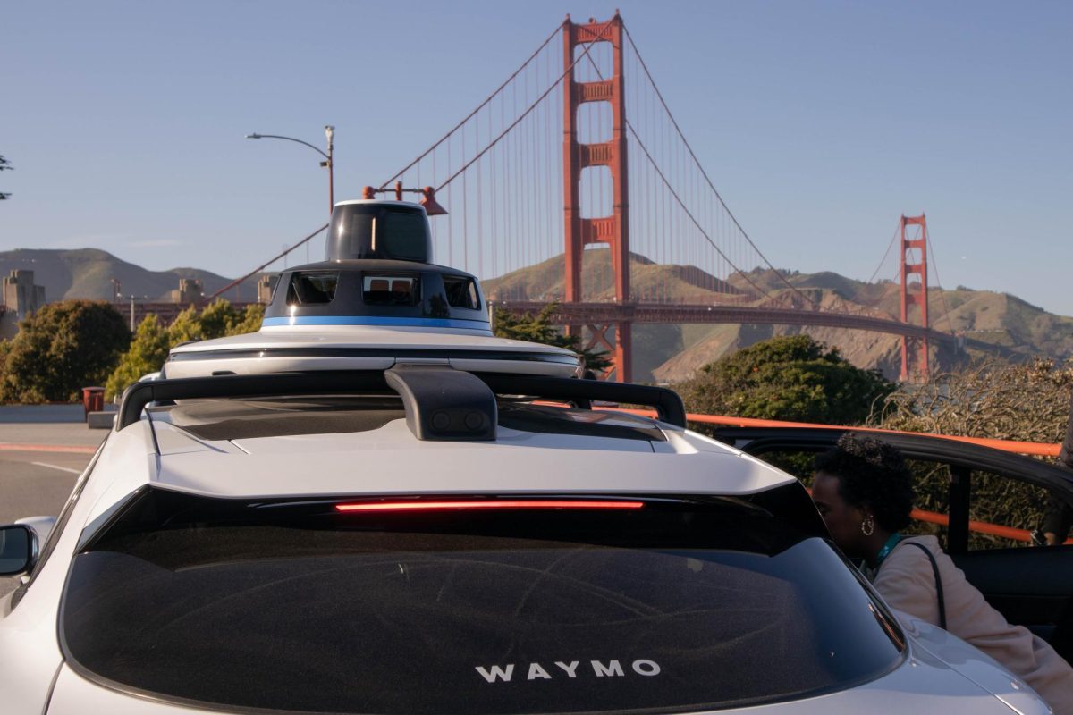 A Waymo sits parked as Samira Hassan, right, gets out of the car at the Golden Gate Bridge Welcome Center in San Francisco, Thursday, March 5, 2026. Photo by Briana Bush/City Times Media