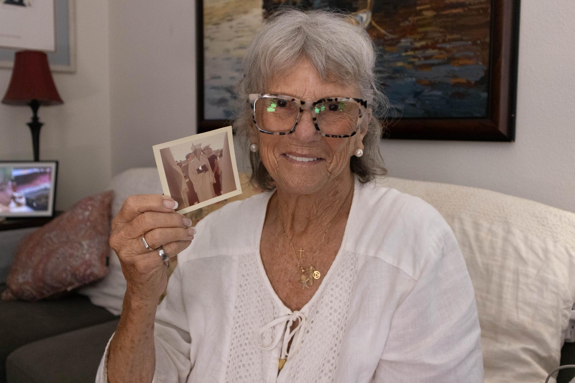 City College student Spirit Fabian smiles as she shows a photo from her high school graduation, she reminisces on the past of her life at the time, Thursday, May 14, 2026. Photo by Briana Bush/City Times Media