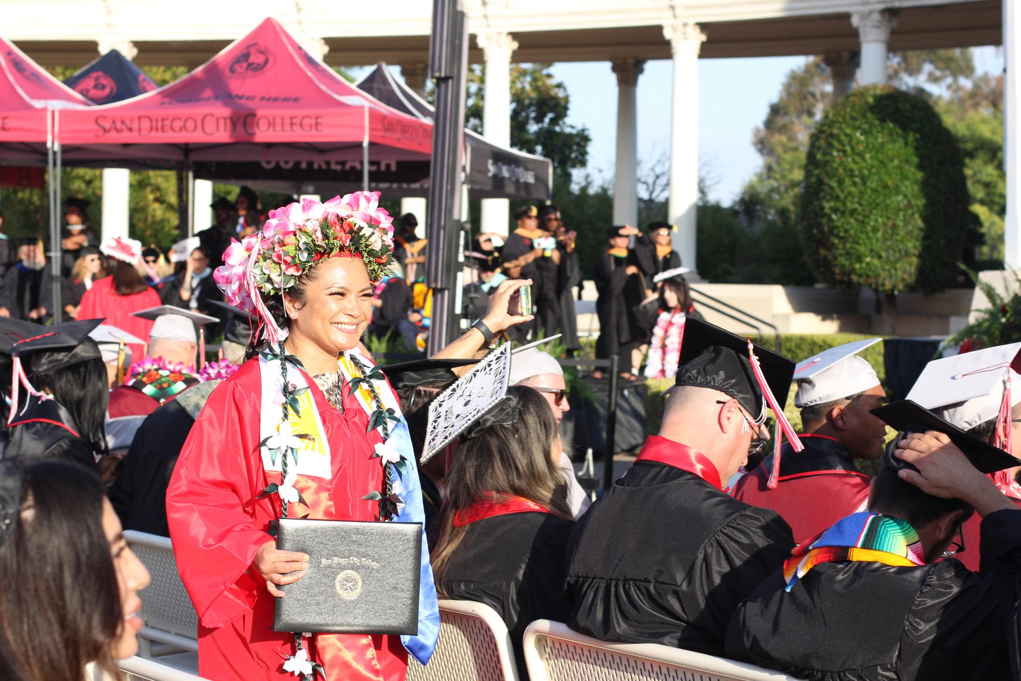 Mary Camila Espiritu walks back to join the other graduates after she receives her diploma at the City College Commencement Ceremony at the Spreckels Organ Pavilion in Balboa Park, Thursday, May 21, 2026. Photo by Angela Galan Martinez/City Times Media