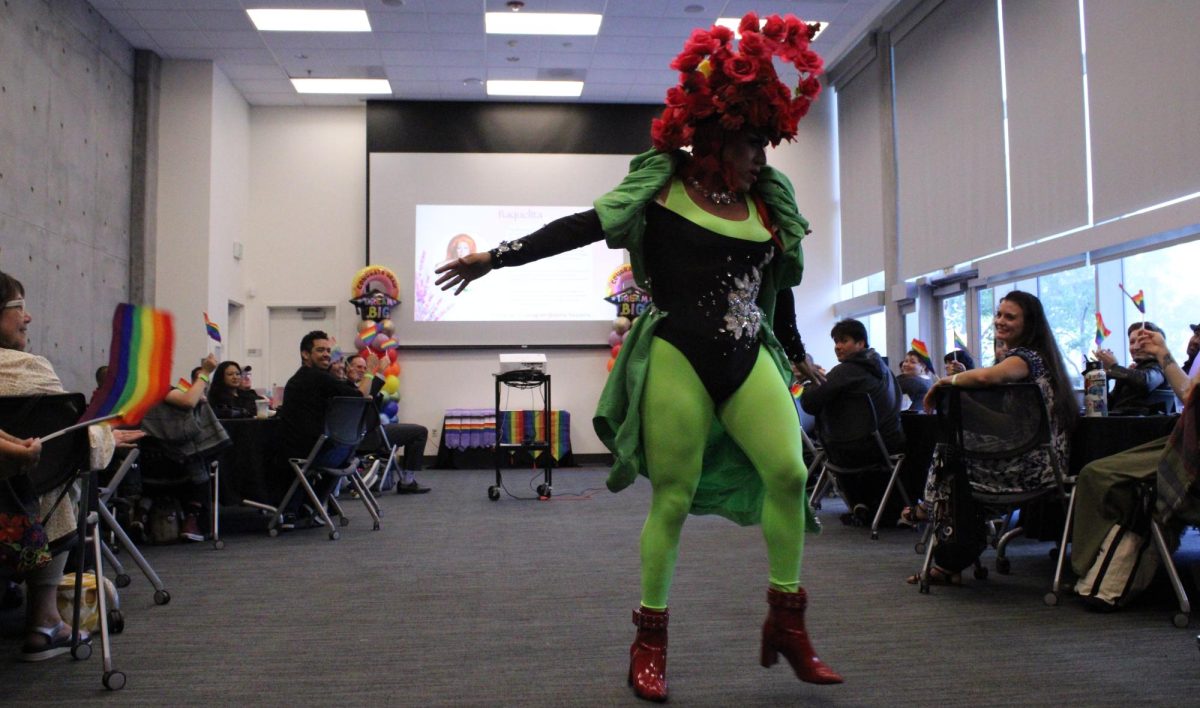 Drag queen Raquelita dances for students and guests as they wave the pride flag at the lavender graduation ceremony in MS-140, Monday, May 18, 2026. Photo by Tresean Osgood/City Times Media