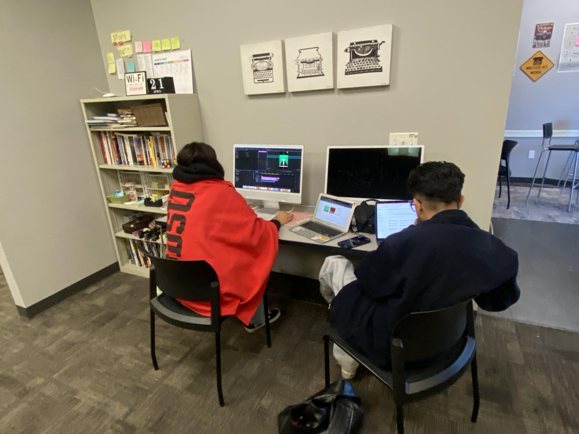Sports editor Itzel Martinez, left, and Mikey Gonzalez, right, work at computers in the City Times Media newsroom as Wi-Fi connections reboot at City College, Thursday, May 14, 2026. Photo by David J. Bohnet/City Times Media
